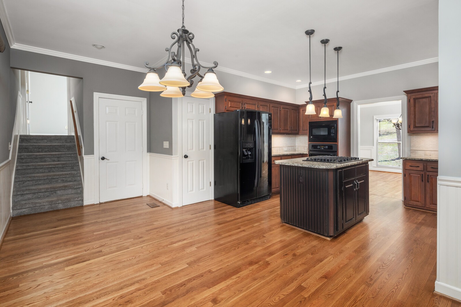341 Sandcastle Road Franklin, TN 37069 - Photo 15 of 41 a kitchen with stainless steel appliances kitchen island granite countertop a refrigerator a stove and a wooden floor