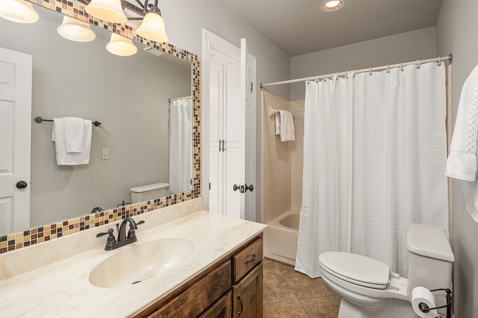 341 Sandcastle Road Franklin, TN 37069 - Photo 26 of 41 a bathroom with a sink a toilet a mirror a vanity and shower