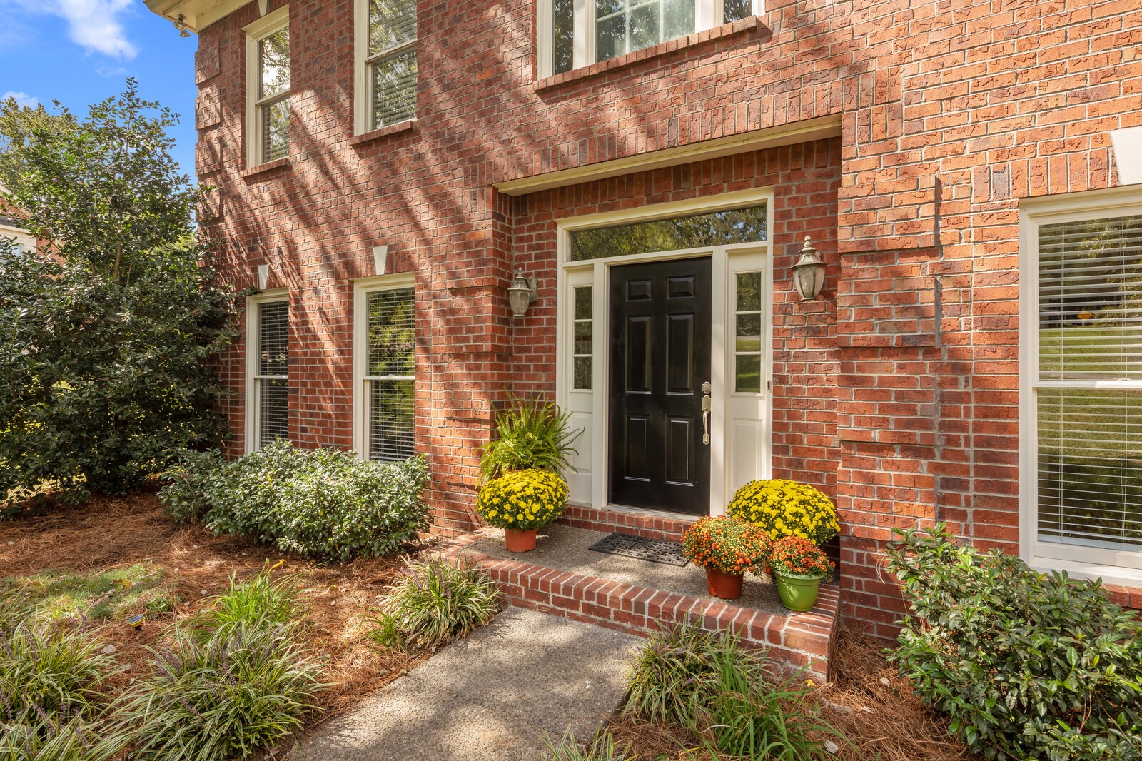 341 Sandcastle Road Franklin, TN 37069 - Photo 4 of 41 a view of a brick house with potted plants