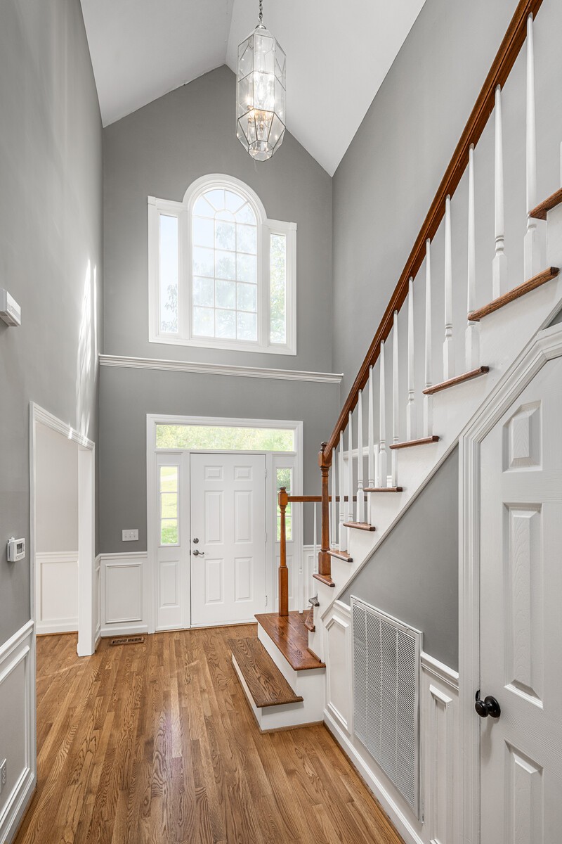341 Sandcastle Road Franklin, TN 37069 - Photo 6 of 41 a view of an entryway with wooden floor and stairs