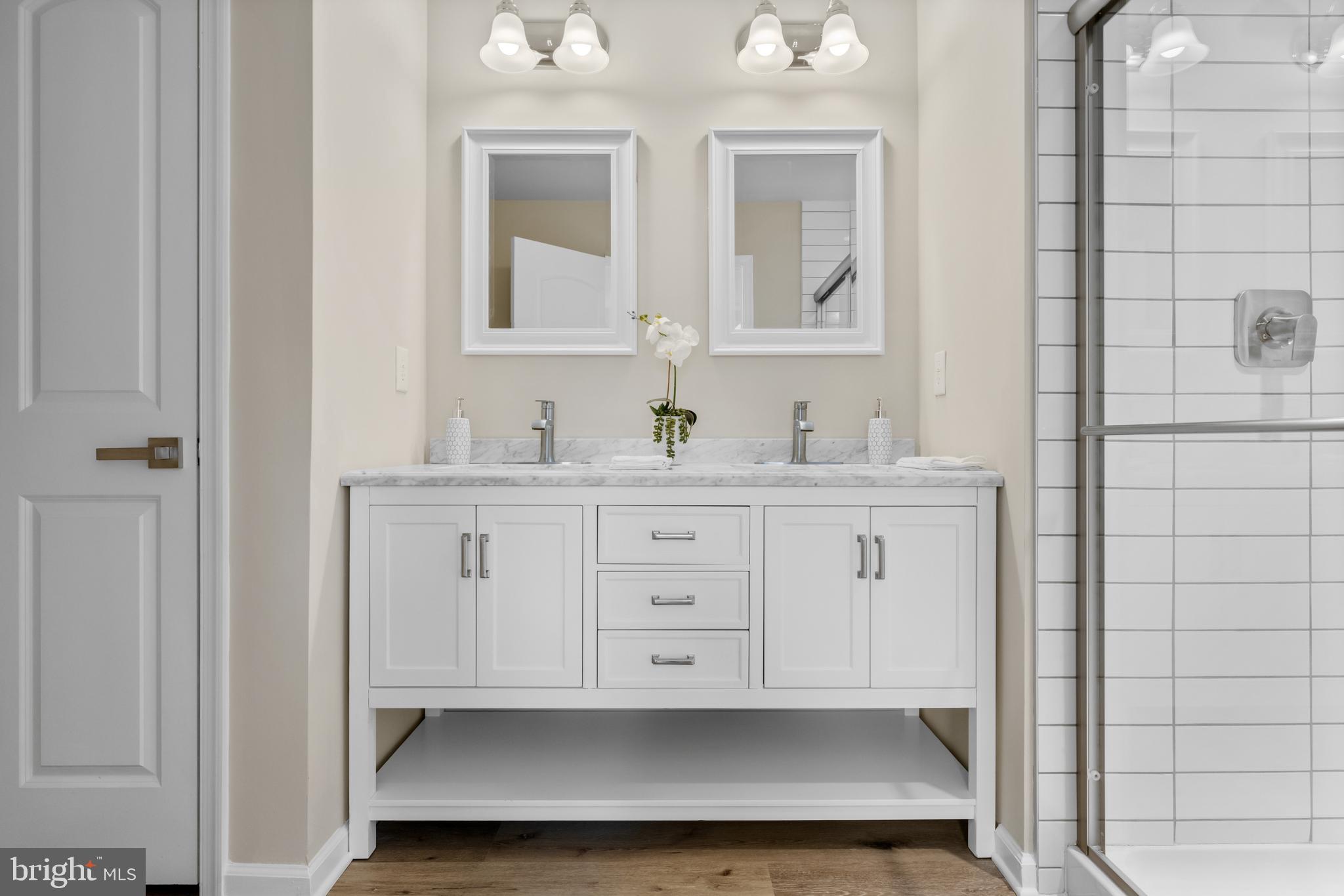 385 North Tuckahoe Road, Unit 949 Williamstown, NJ 08094 - Photo 13 of 21 a bathroom with a double vanity sink a mirror and a