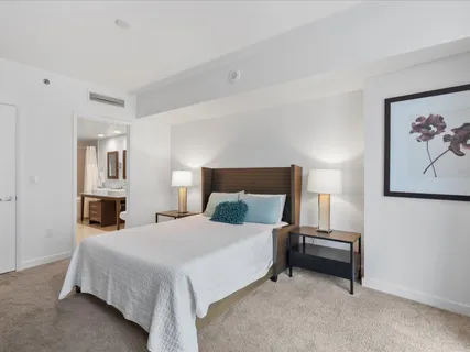 a bedroom with a bed and a painting on the wall