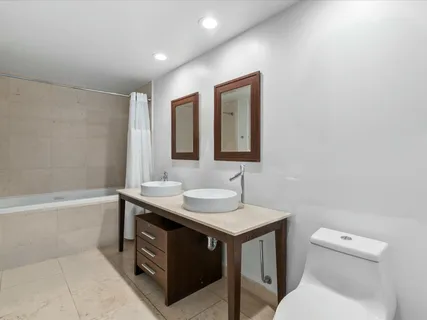 a bathroom with a sink toilet vanity and tub