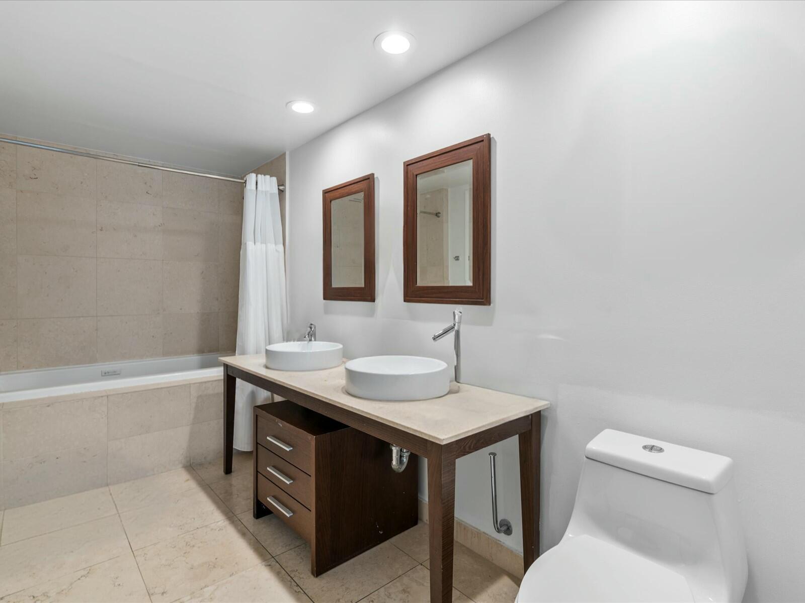 485 Brickell Avenue, Unit 2107 Miami, FL 33131 - Photo 10 of 18 a bathroom with a sink toilet vanity and tub