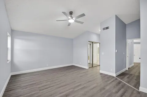 a bathroom with a sink vanity granite tub and a mirror