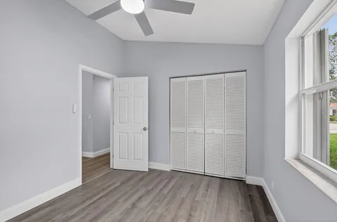 a bedroom with a bed a couch and a window