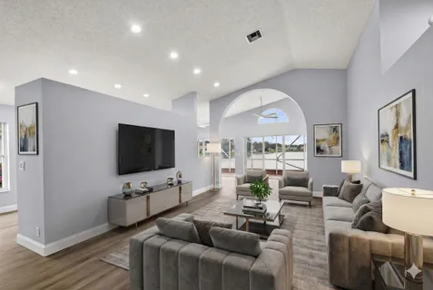a view of a big room with wooden floor table and chairs