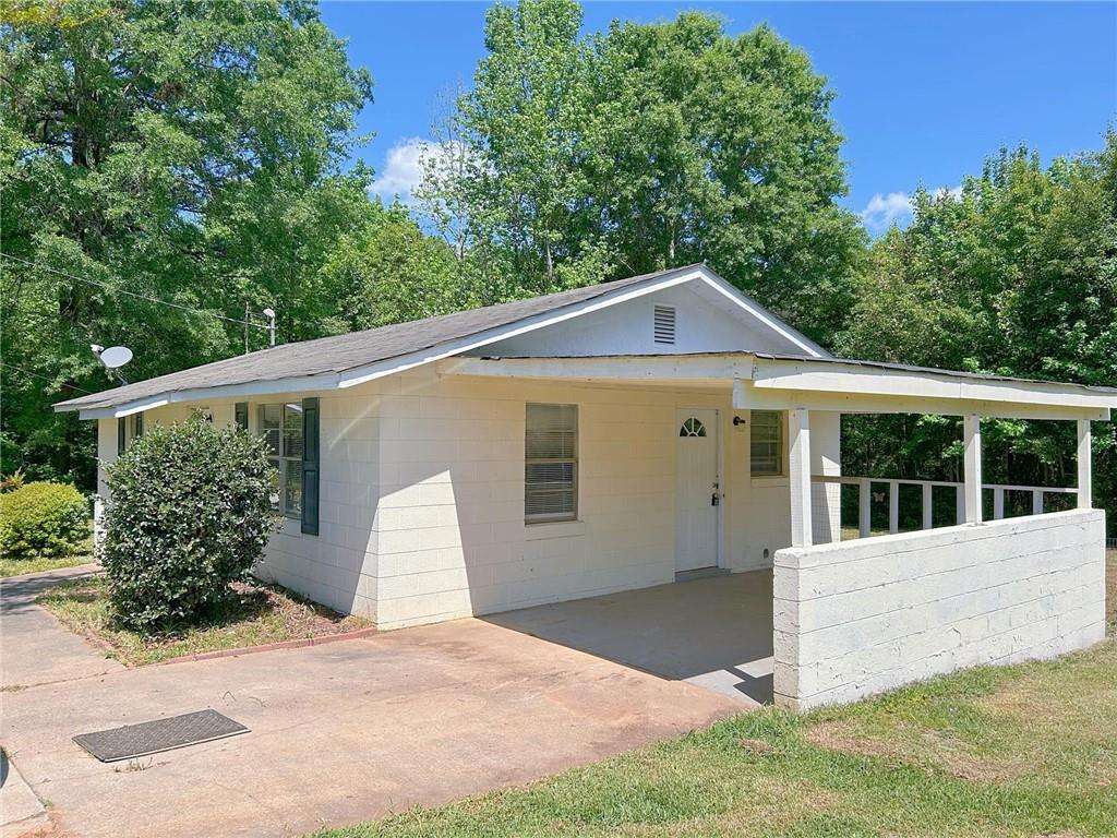 a front view of a house with a yard and trees