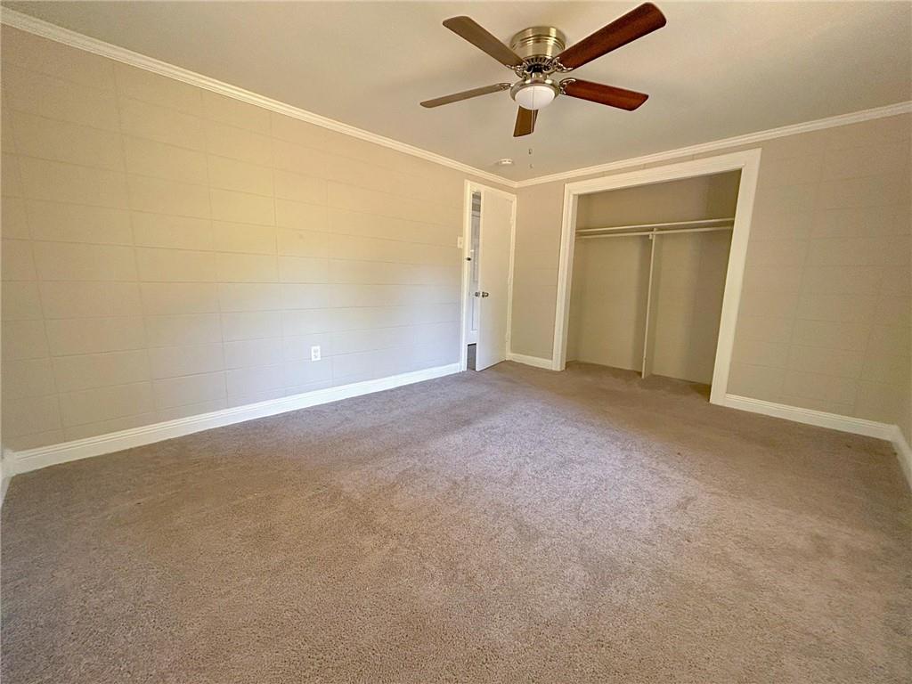 271 Rehoboth Road Griffin, GA 30223 - Photo 8 of 9 an empty room with closet and a ceiling fan