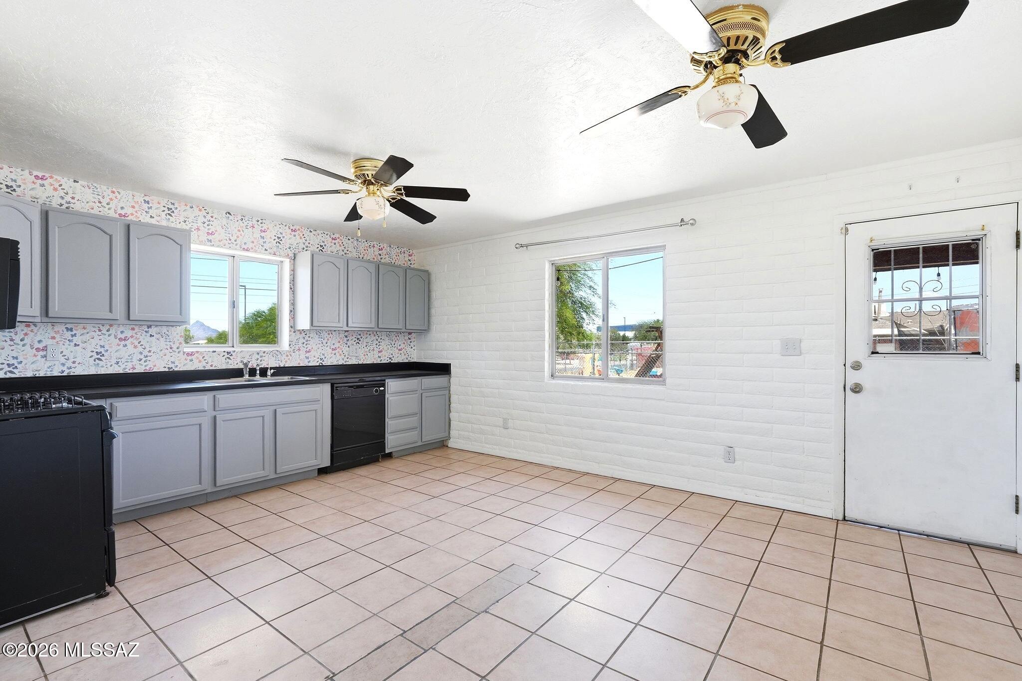 5125 South Missiondale Road Tucson, AZ 85706 - Photo 9 of 32 a kitchen with a sink a stove cabinets and window