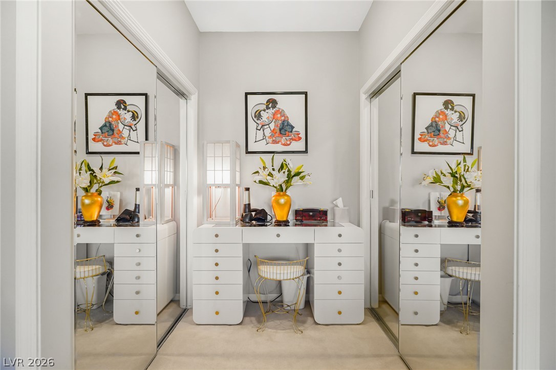 2738 Grand Forks Road Henderson, NV 89052 - Photo 23 of 52 Mirrored sliding doors flank a built-in dressing vanity area with clean architectural lines.