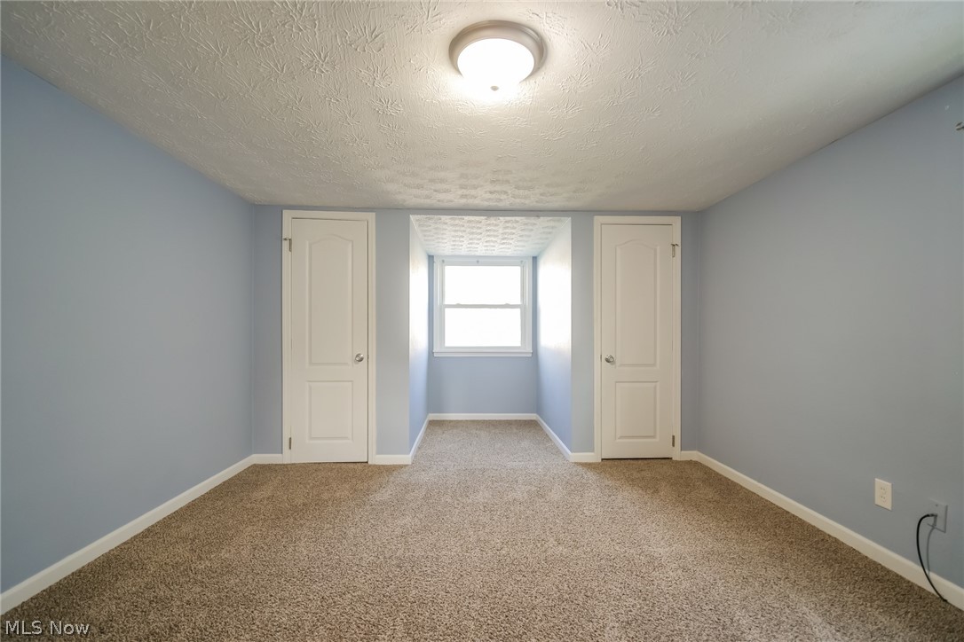 736 Quilliams Road Cleveland Heights, OH 44121 - Photo 15 of 20 Unfurnished bedroom with light carpet and a textured ceiling