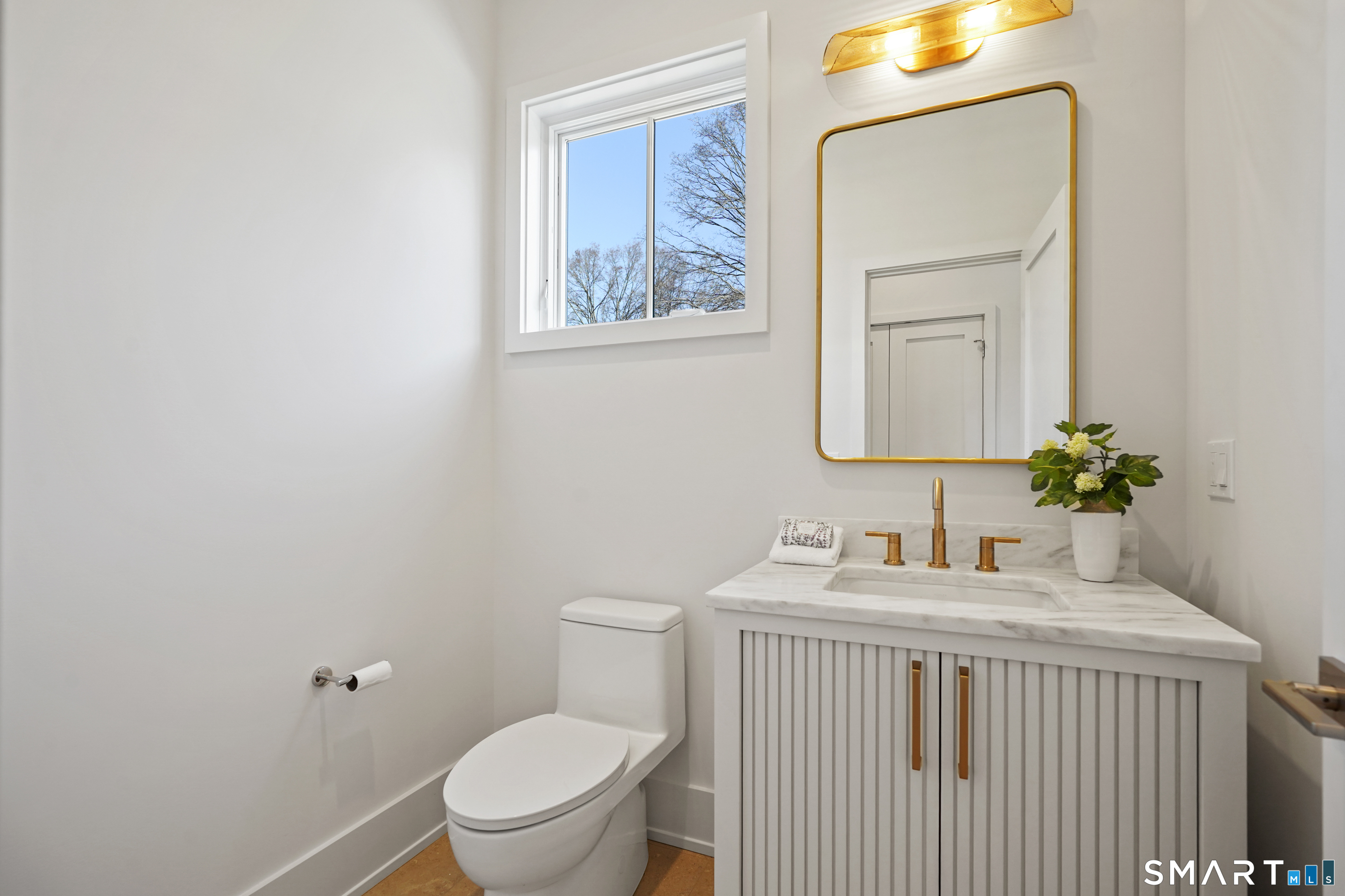 18 Woodhill Road Westport, CT 06880 - Photo 18 of 38 a bathroom with a toilet sink vanity and mirror