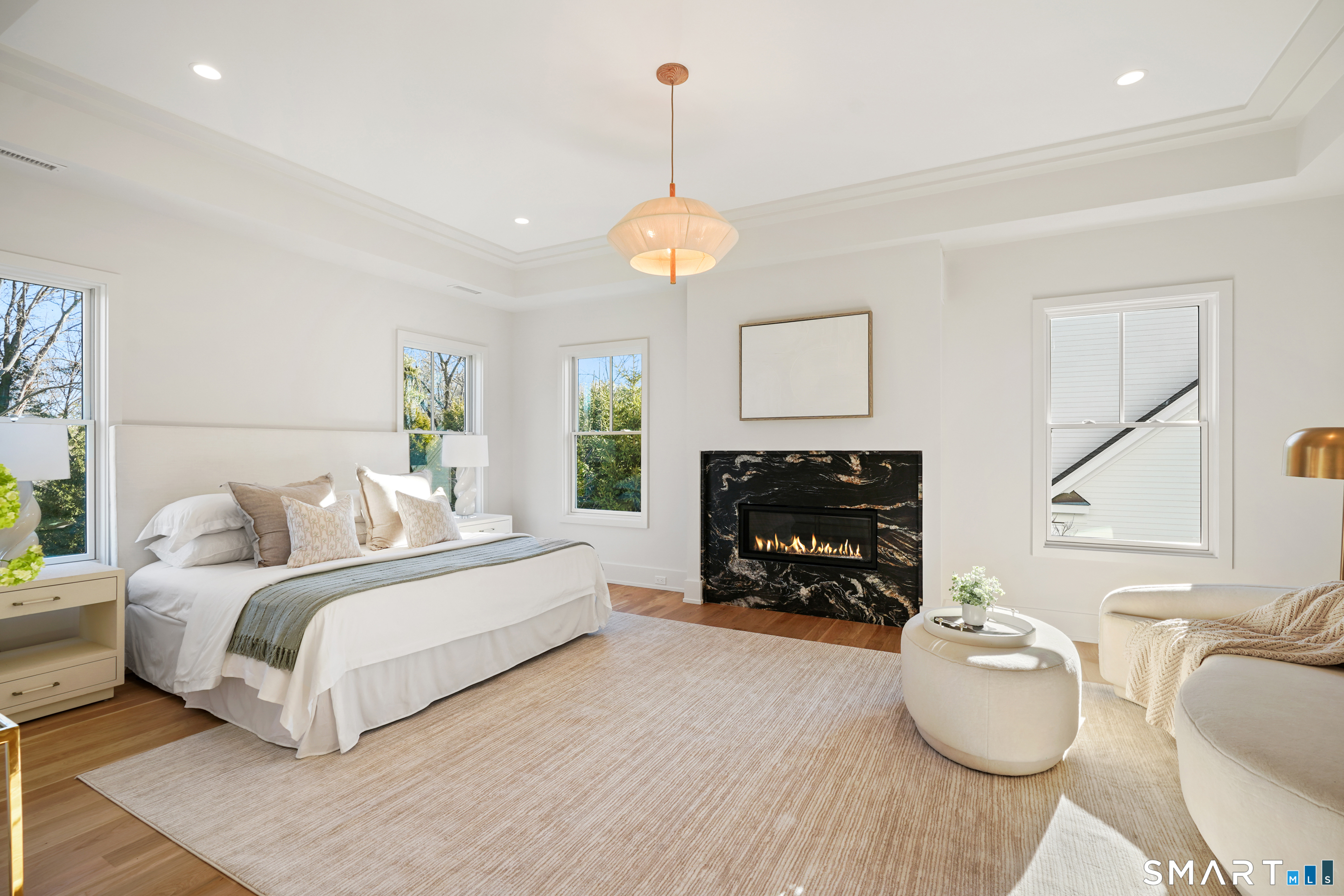 18 Woodhill Road Westport, CT 06880 - Photo 20 of 38 a living room with furniture a fireplace and a chandelier