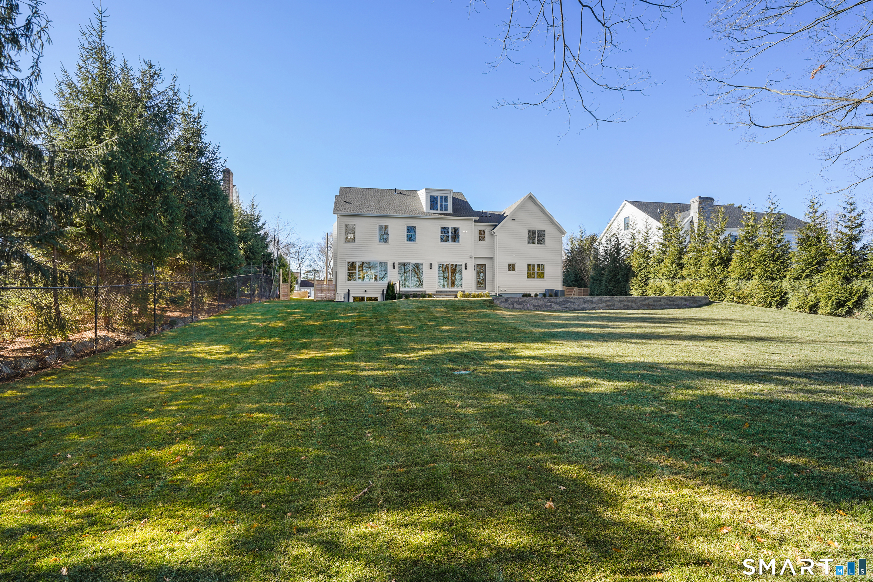 18 Woodhill Road Westport, CT 06880 - Photo 2 of 38 a view of a big house with a big yard