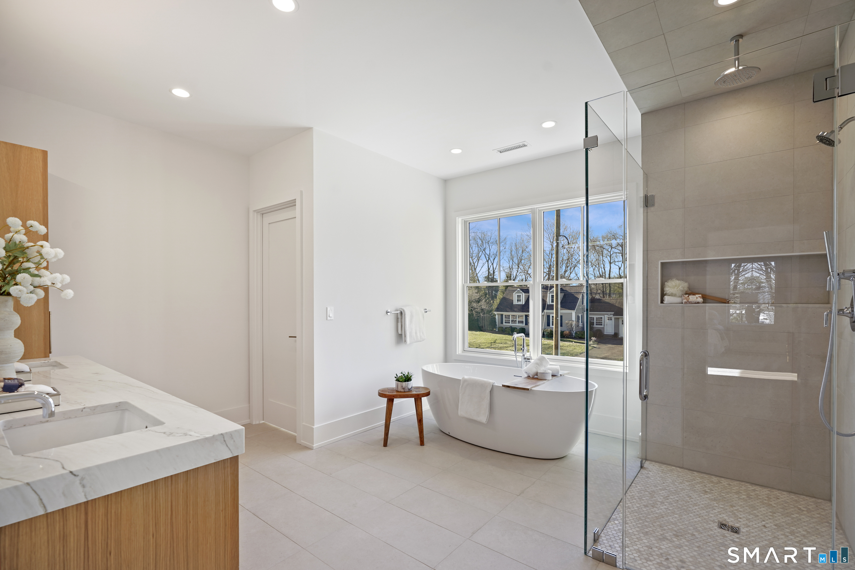 18 Woodhill Road Westport, CT 06880 - Photo 23 of 38 a bathroom with a tub sink shower and mirror