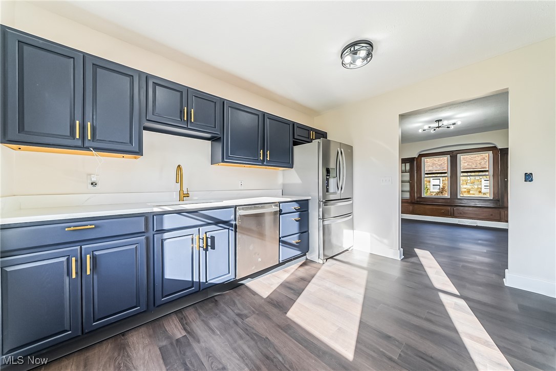 36336 Butternut Ridge Road North Ridgeville, OH 44039 - Photo 12 of 42 Kitchen with dark wood-type flooring, blue cabinetry, sink, and stainless steel appliances