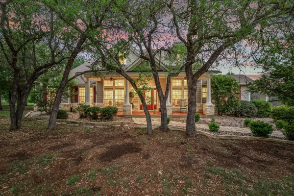 a view of a backyard with wooden fence