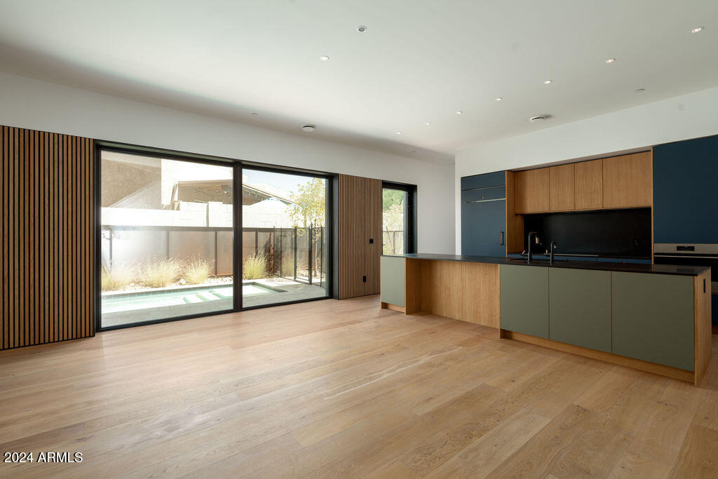 1740 East Ocotillo Road, Unit 4 Phoenix, AZ 85016 - Photo 2 of 20 a view of an empty room with a flat screen tv and floor to ceiling window
