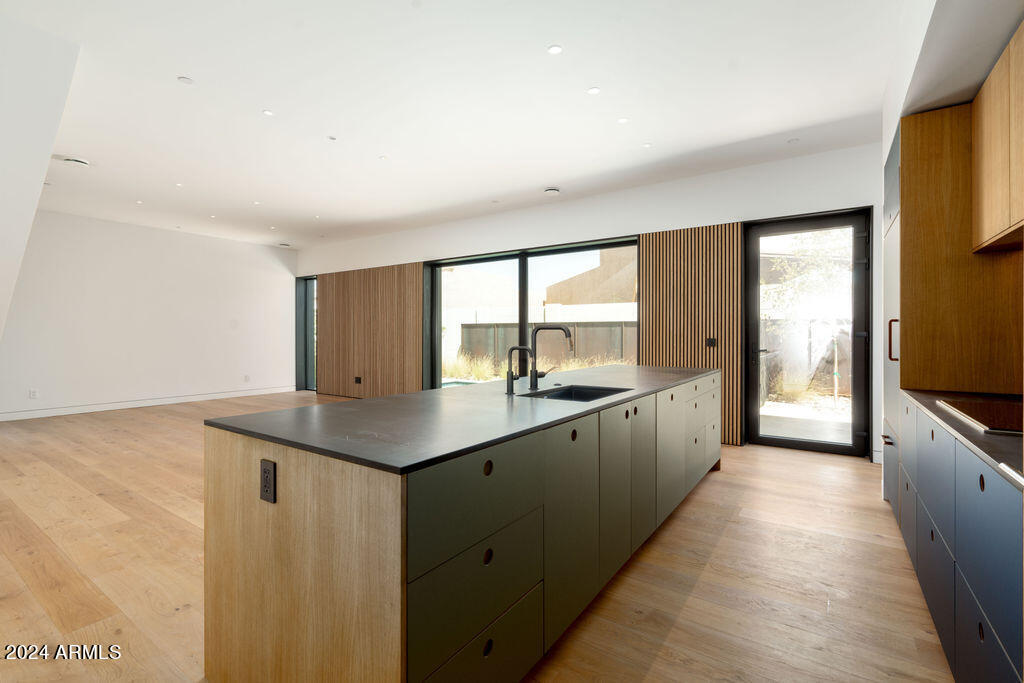 1740 East Ocotillo Road, Unit 4 Phoenix, AZ 85016 - Photo 3 of 20 a kitchen with granite countertop a sink and a refrigerator