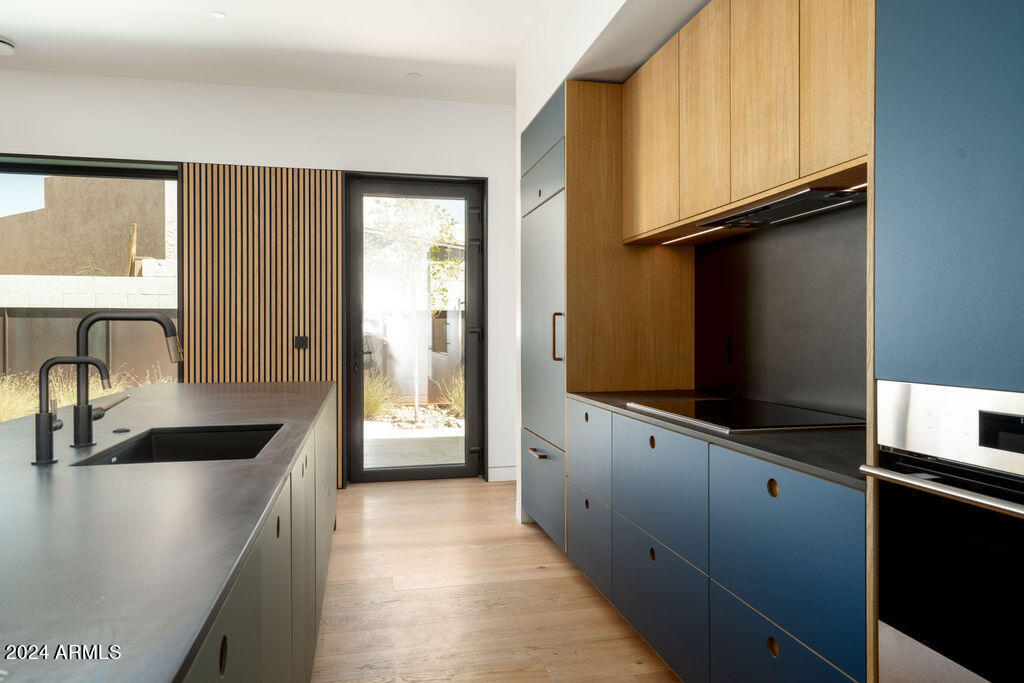 1740 East Ocotillo Road, Unit 4 Phoenix, AZ 85016 - Photo 4 of 20 a kitchen with granite countertop a sink and a refrigerator