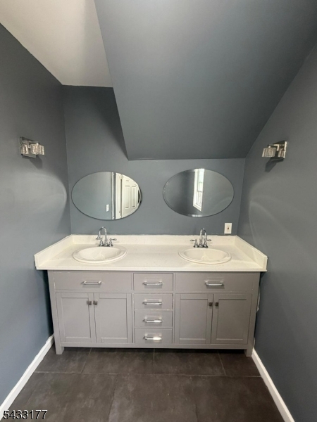 166 Renner Avenue, Unit 3 Newark, NJ 07112 - Photo 11 of 24 a bathroom with a double vanity sink and a mirror