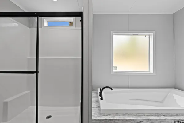 a bathroom with a double vanity sink and mirror