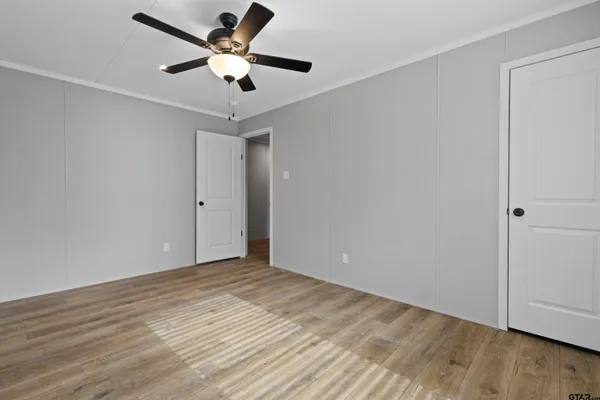 a view of a hallway with wooden floor