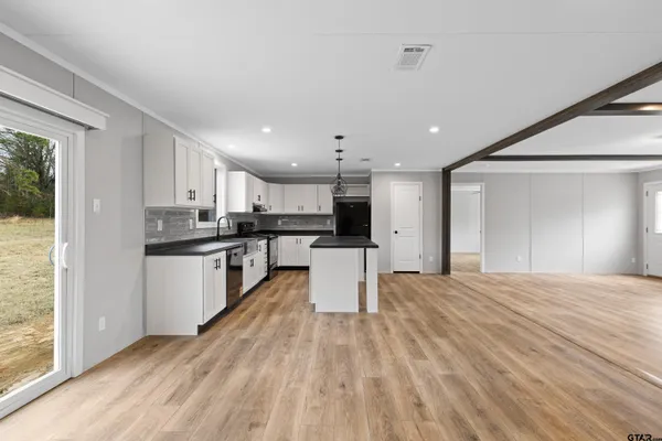 a kitchen with stainless steel appliances granite countertop a granite counter tops and a window
