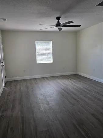 a view of a room with wooden floor closet and windows