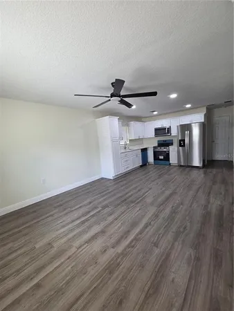 a view of a room with wooden floor