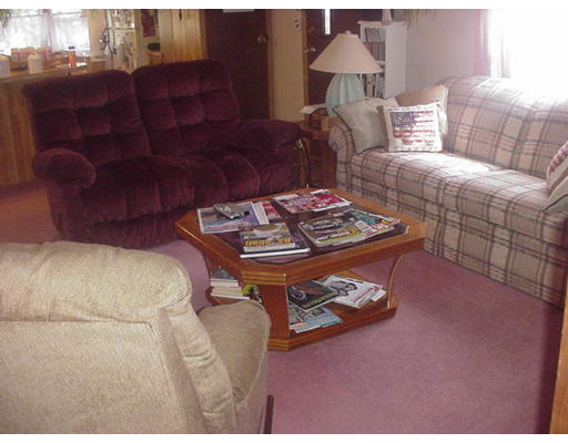 31 Longboat Road, Unit 31 Wareham, MA 02576 - Photo 5 of 14 a living room with furniture and a dining table