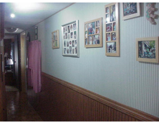 31 Longboat Road, Unit 31 Wareham, MA 02576 - Photo 6 of 14 a view of a hallway with paintings on the wall