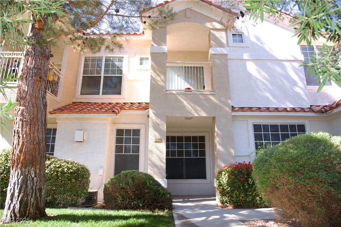 8555 West Russell Road, Unit 1078 Las Vegas, NV 89113 - Photo 1 of 34 Mediterranean / spanish-style home with a balcony, a tiled roof, and stucco siding