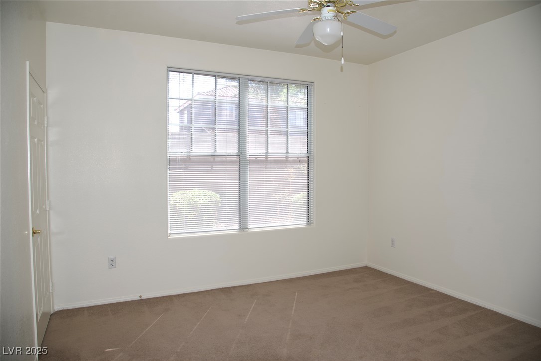 8555 West Russell Road, Unit 1078 Las Vegas, NV 89113 - Photo 25 of 34 Carpeted spare room with baseboards and ceiling fan