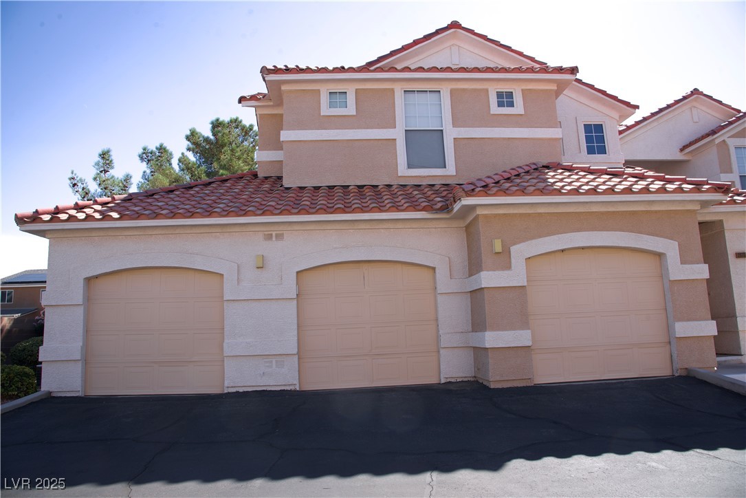 8555 West Russell Road, Unit 1078 Las Vegas, NV 89113 - Photo 3 of 34 Mediterranean / spanish-style home featuring stucco siding and a tiled roof