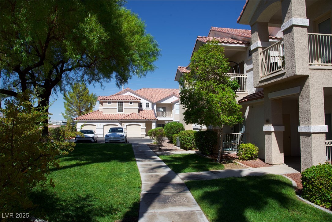 8555 West Russell Road, Unit 1078 Las Vegas, NV 89113 - Photo 33 of 34 View of home's community featuring a lawn and a balcony