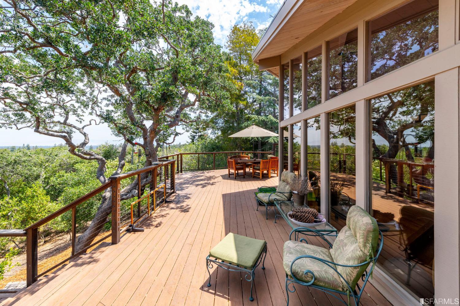 250 Hardwick Road Woodside, CA 94062 - Photo 31 of 50 a view of a patio with couches table and chairs and wooden floor
