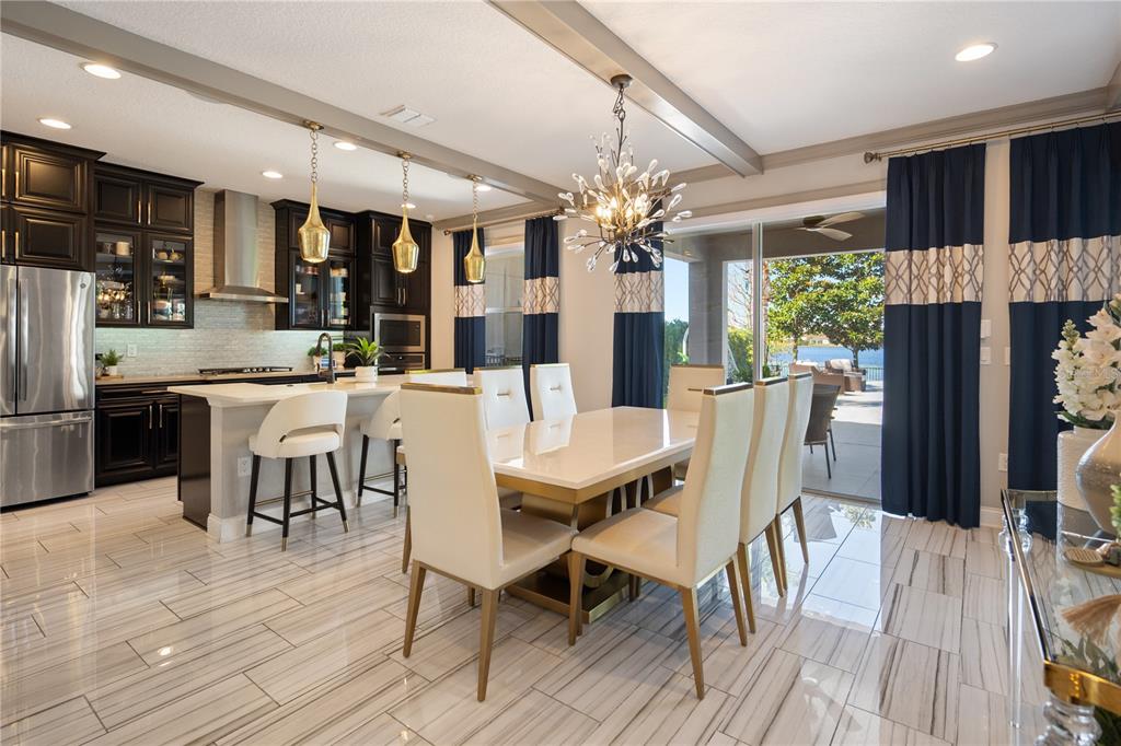 10950 Lemon Lake Boulevard Orlando, FL 32836 - Photo 12 of 53 a dining room with furniture a kitchen a chandelier and wooden floor