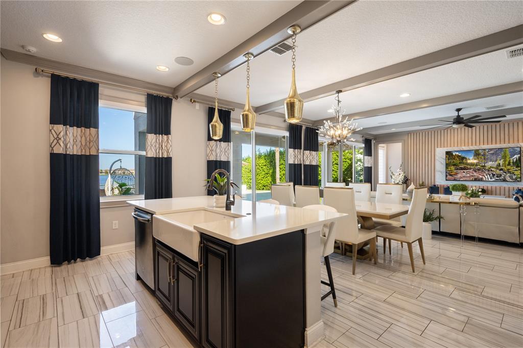 10950 Lemon Lake Boulevard Orlando, FL 32836 - Photo 14 of 53 a large white kitchen with a table and chairs