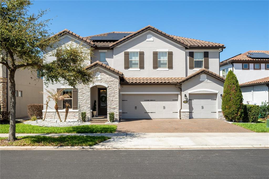 10950 Lemon Lake Boulevard Orlando, FL 32836 - Photo 2 of 53 a front view of a house with a yard and garage
