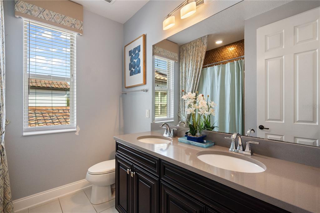 10950 Lemon Lake Boulevard Orlando, FL 32836 - Photo 24 of 53 a bathroom with a granite countertop sink and a mirror with window