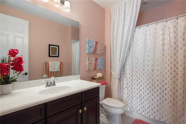 a bathroom with a sink toilet and a mirror