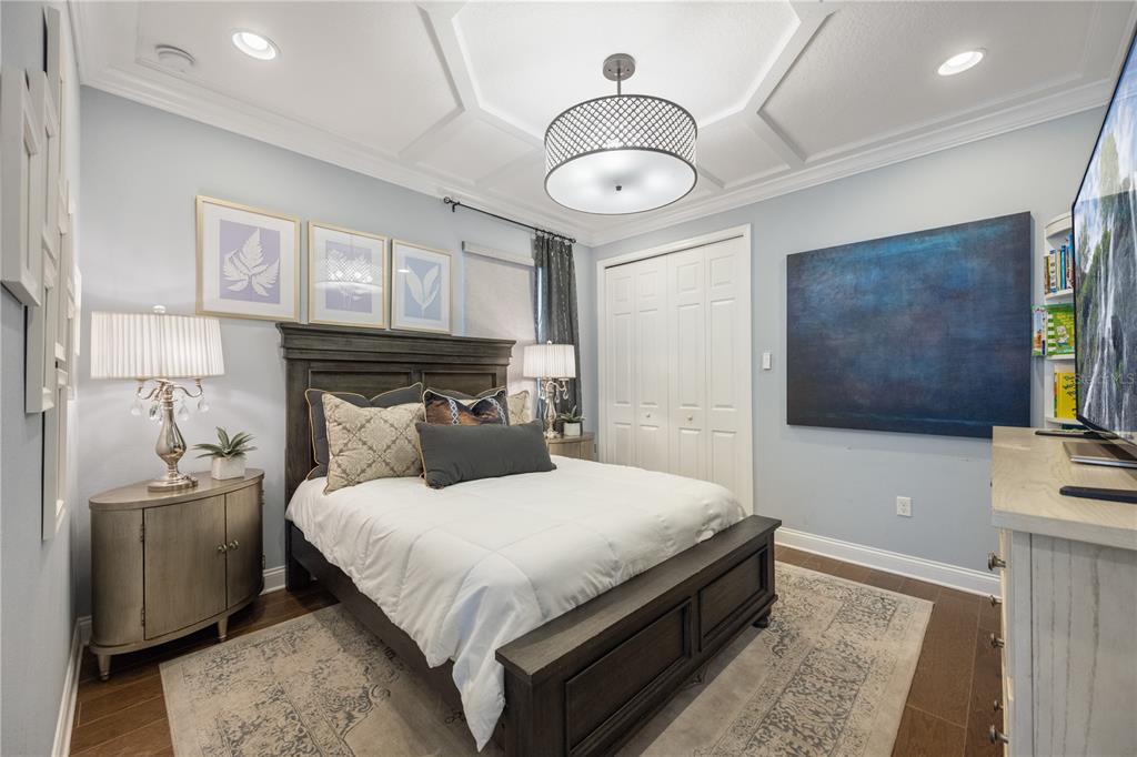 10950 Lemon Lake Boulevard Orlando, FL 32836 - Photo 28 of 53 a bedroom with a large bed and a chandelier