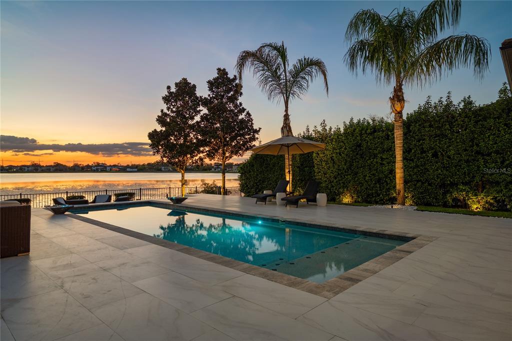 10950 Lemon Lake Boulevard Orlando, FL 32836 - Photo 36 of 53 a view of a swimming pool with a patio and a garden