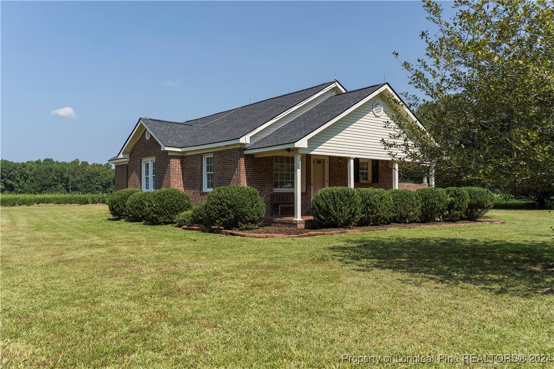 2766 Howard Road Autryville, NC 28318 - Photo 23 of 39 a front view of a house with garden