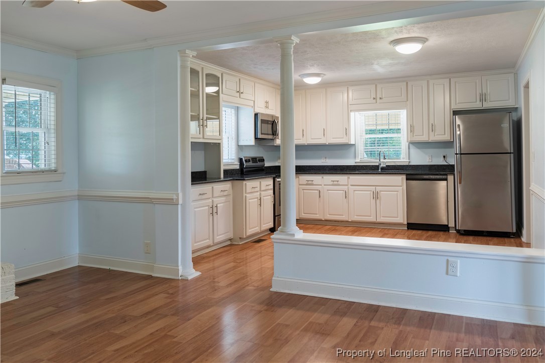 2766 Howard Road Autryville, NC 28318 - Photo 3 of 39 a kitchen with granite countertop a refrigerator and a stove top oven