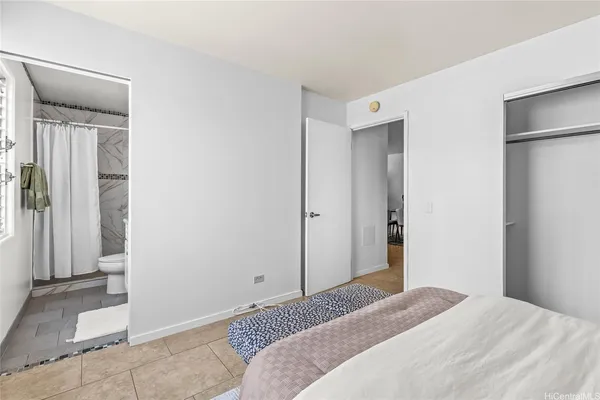 a bedroom with a bed and a mirror