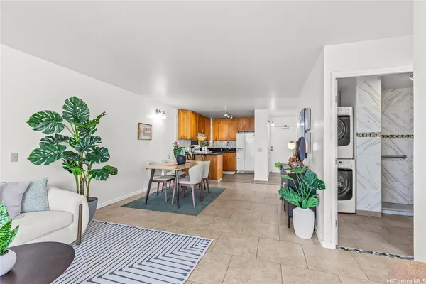 a living room with furniture potted plant and a mirror
