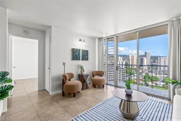 a living room with furniture and a floor to ceiling window